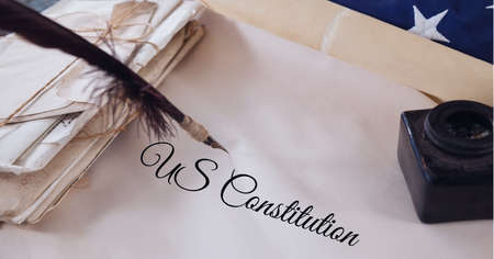Composition of text us constitution, with quill pen and inkwell on antique documents. patriotism, independence and american constitution celebration concept digitally generated image.の写真素材