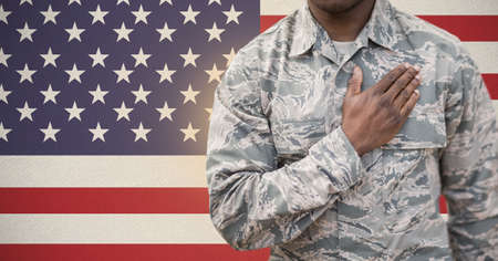 Composition of midsection of soldier with hand on heart, against american flag. patriotism,...