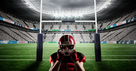 Composition of male american football player holding helmet at stadium. sport and competition...