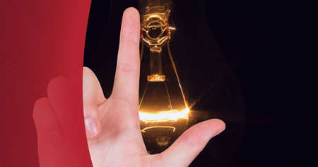 Composition of finger touching screen with lightbulb on black background. global business, digital...