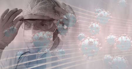 Animation of covid 19 cells and medical worker in ppe suit. global covid 19 pandemic concept digitally generated video.の写真素材