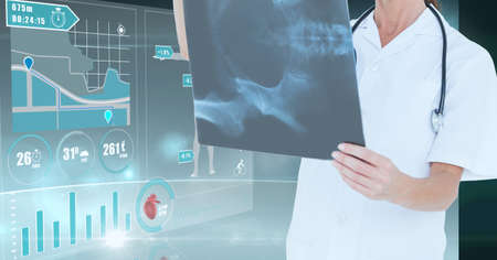 Medical data processing against mid section of female doctor examining x-ray report. medical...