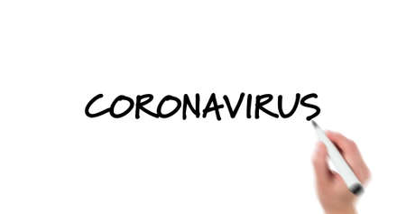 Image of a person writing black words, Coronavirus message on white background. Global pandemic coronavirus Covid 19 outbreak concept digital compositionの写真素材