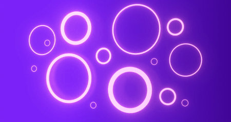 Pulsating pink neon rings in various sizes glowing on purple background. energy, electricity, luminosity, colour and movement concept, digitally generated image.の写真素材
