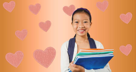Composition of hearts over girl with notebooks. girl power, positive female strength and...