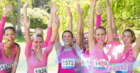 Composition of pink breast cancer ribbon and globe over group of smiling women. breast cancer positive awareness campaign concept digitally generated image.の写真素材