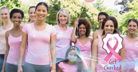 Composition of pink breast cancer ribbon over group of smiling women. breast cancer positive awareness campaign concept digitally generated image.の写真素材