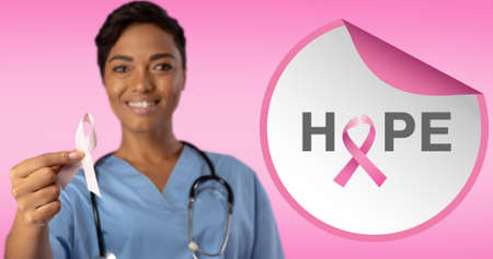 Composition of pink ribbon icon and breast cancer text, with a smiling female doctor. breast cancer positive awareness campaign concept digitally generated image.の写真素材