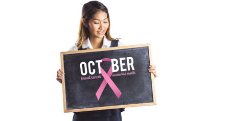 Composition of young smiling woman with pink ribbon logo and breast cancer text on white background. breast cancer positive awareness campaign concept digitally generated image.の写真素材