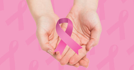 Composition of pink ribbon icon above hands. breast cancer positive awareness campaign concept digitally generated image.の写真素材