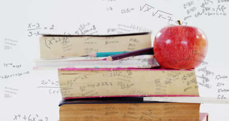 Image of mathematical formulae over stack of books and apple in the background. Science problem...