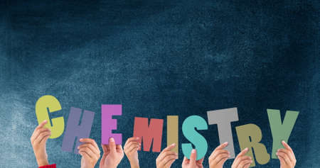 Image of schoolkids holding chemistry text over black background. education, development and learning concept digitally generated image.の写真素材