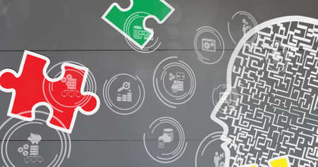 Image of puzzles falling with digital icons on grey background. autism and learning difficulties awareness and support concept digitally generated image.の写真素材