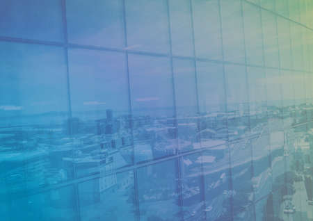 Composition of colorful light over cityscape reflected in window. business template concept digitally generated image.の写真素材