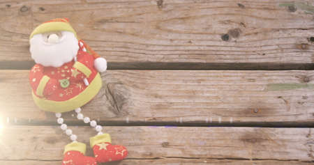 Image of santa claus christmas decoration on wooden surface. christmas festivity celebration concept digitally generated image.の写真素材