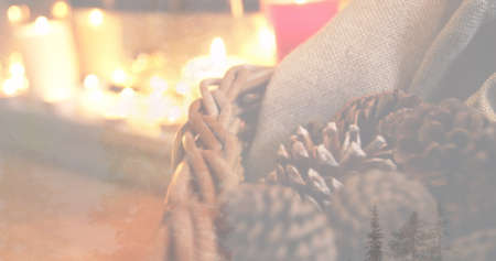 Image of candles and christmas decoration with pine cones. christmas festivity celebration concept digitally generated image.の写真素材