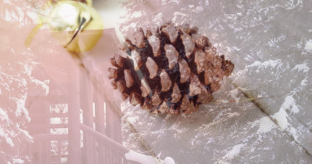 Image of christmas decoration with pine cone over winter scenery. christmas festivity celebration concept digitally generated image.の写真素材