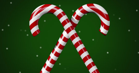Digital image of multiple stars moving over two christmas candy cane against green background. christmas festivity celebration tradition conceptの写真素材