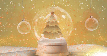 Digital image of snow falling over shooting star spinning around christmas tree in snow globe and hand decoration against yellow background. christmas festivity celebration tradition conceptの写真素材
