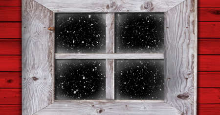 Image of winter scenery at Christmas time with snow falling seen through a window at night 4kの写真素材