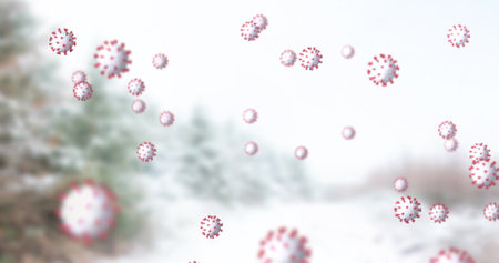 Image of cells moving over winter scenery with fir trees in the background. christmas time during virus pandemic concept digitally generated image.の写真素材