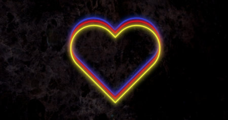 Image of red yellow and blue neon hearts flashing on dark wall. valentines day, love and romance concept, digitally generated image.の写真素材