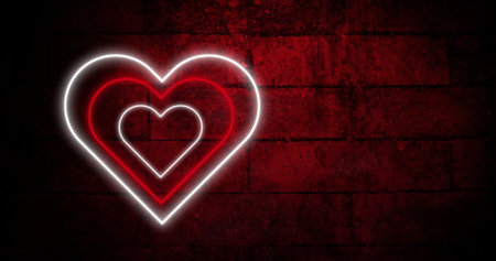 Image of red and white concentric neon hearts flashing on dark brick wall. valentines day, love and romance concept, digitally generated image.の写真素材