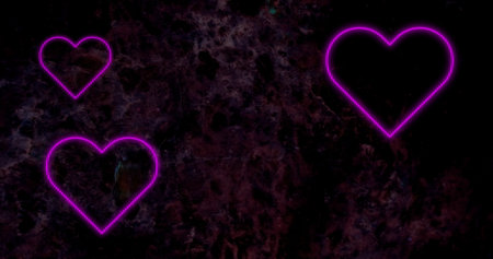 Image of pink neon hearts flashing on dark cherry blossom background. valentine's day, love and romance concept, digitally generated image.の写真素材