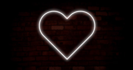 Image of white neon heart flashing on dark brick wall background. valentines day, love and romance concept, digitally generated image.の写真素材
