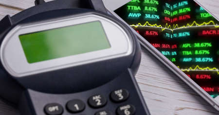 Image of financial data processing on smartphone next to payment terminal. global finances, business...