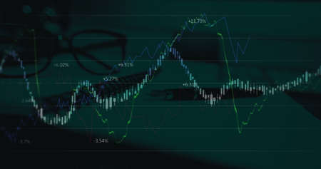 Image of financial data processing over pen, notebook and glasses. global business and finances concept digitally generated image.の写真素材