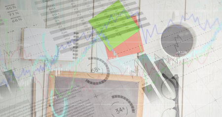 Image of financial data processing over tablet on desk. digital interface, global finance and business concept digitally generated image.の写真素材