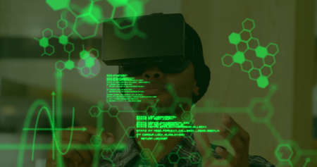 Image of scientific data in green floating in the foreground with a young mixed race man wearing a...