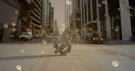 Image of bitcoin symbols floating over crashing American dollar symbol with cityscape in the background. Global finance business cryptocurrency market concept digitally generated image.の写真素材