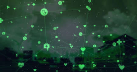 Digital composite image of Globe of green glowing digital icons against clouds over cityscape in...