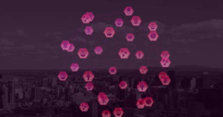 Digital composite image of globe of pink digital icons over cityscape against purple background. Global networking and connection conceptの写真素材