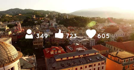 High angle of a town in the background of digital image of heart, like and follow icons with numbers...