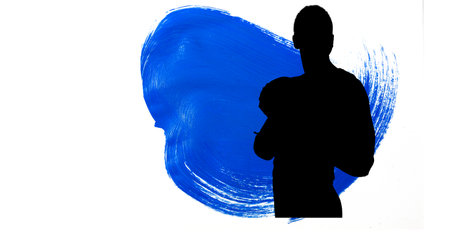 Silhouette of female handball player against blue paint brush strokes on white background. sports and competition conceptの写真素材
