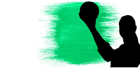 Silhouette of female handball player against green paint brush strokes on white background. sports and competition conceptの写真素材