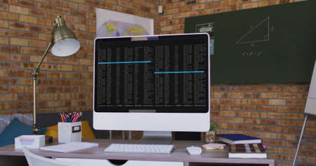 Computer screen with data processing standing on desk in office. computer coding, data technology...
