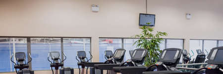 View of interior of a modern gym with sports equipment. gym, fitness and healthy lifestyle concept
