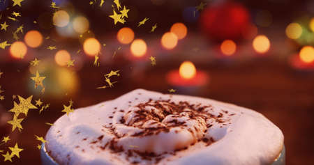 Image of stars flying over christmas hot chocolate drink and candles. christmas christmas, tradition and celebration concept digitally generated image.の写真素材