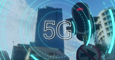 Digital image of futuristic circles moving around 5G with background of a stop light and buildings...