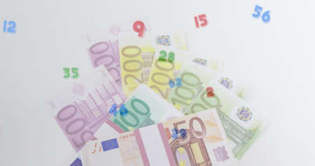 Digital composition of multiple numbers and symbols floating against euro bills. global finances and...