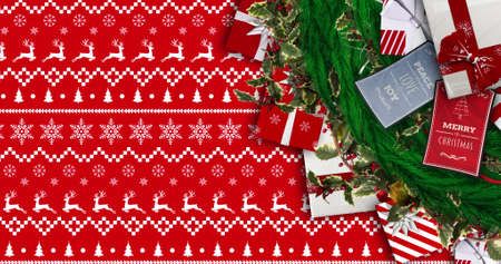 Image of fir tree branches and gifts over christmas pattern. christmas, tradition and celebration...