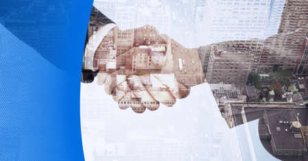Composition of businessmen shaking hands over cityscape with blue border. business, success and connections concept digitally generated image.の写真素材