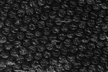 Reflecting light and shadow on creases and folds in plastic wrap sheeting. monochrome light and texture, abstract background image.の写真素材