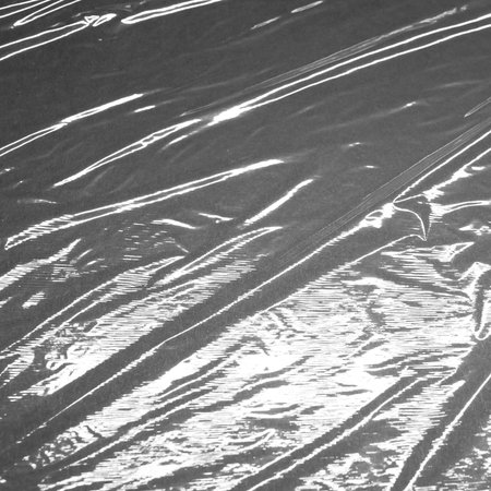 Reflecting light and shadow on creases and folds in shiny fabric or plastic sheeting. monochrome light and texture, abstract background image.の写真素材