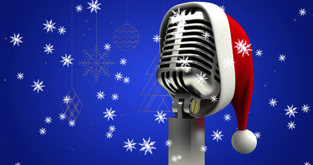 Image of santa hat on vintage microphone and snow falling on blue background. christmas, tradition and celebration concept digitally generated image.の写真素材
