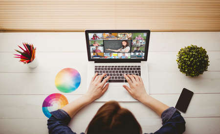 Overhead view of businesswoman using laptop at her deskの写真素材